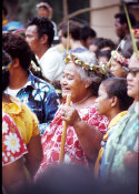 Wilcommen, No. 0036 An Older Carolinian Woman Smiles With Red-Stained Teeth While Watching a Traditional Dance